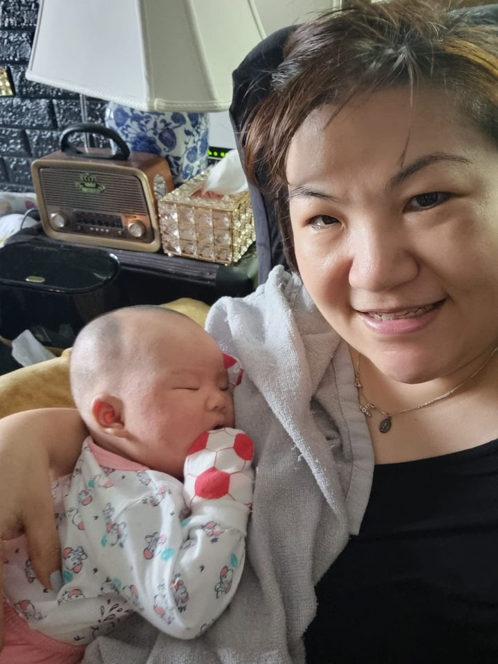 Happy little one in Aunty Jade's care