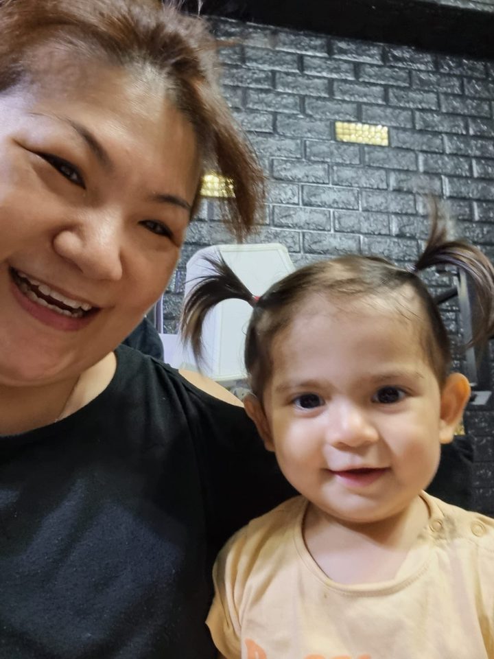 Happy little one in Aunty Jade's care